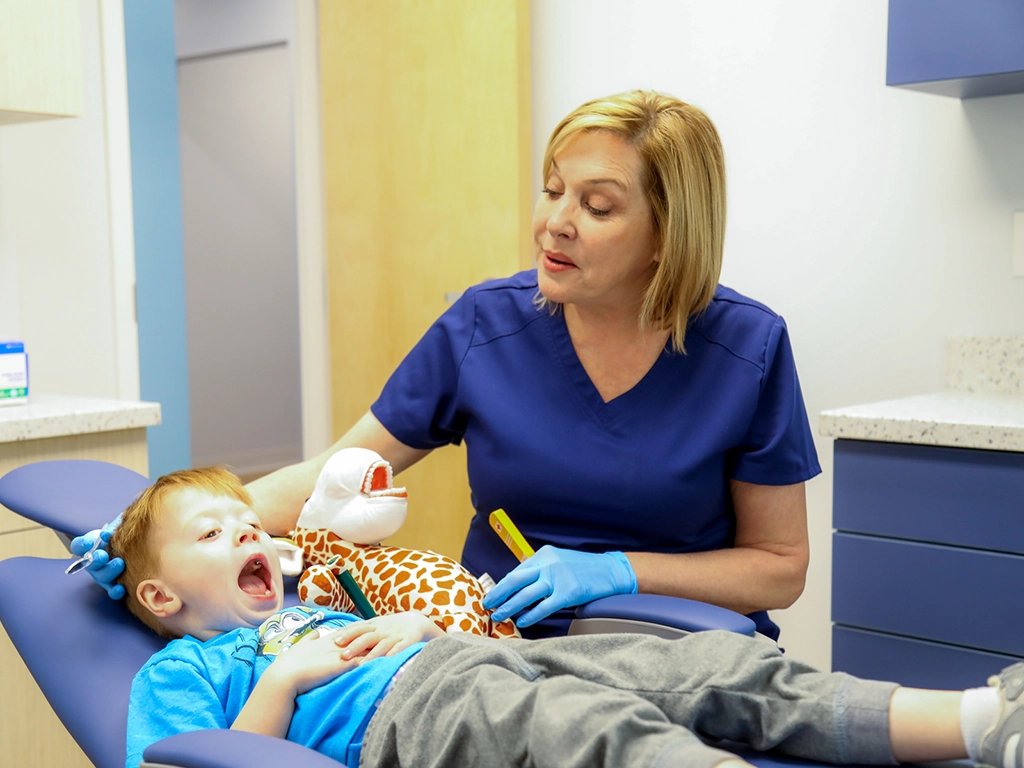 Dr. Sharon seeing young patient's teeth during Dental Exam